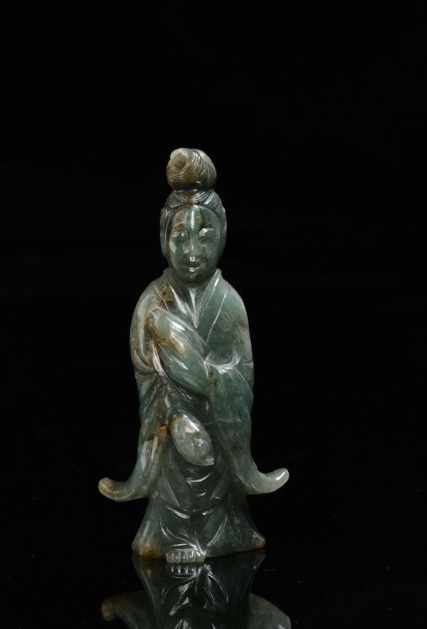 A green jade and russet Guanyin, China, Qing Dynasty, 19th century