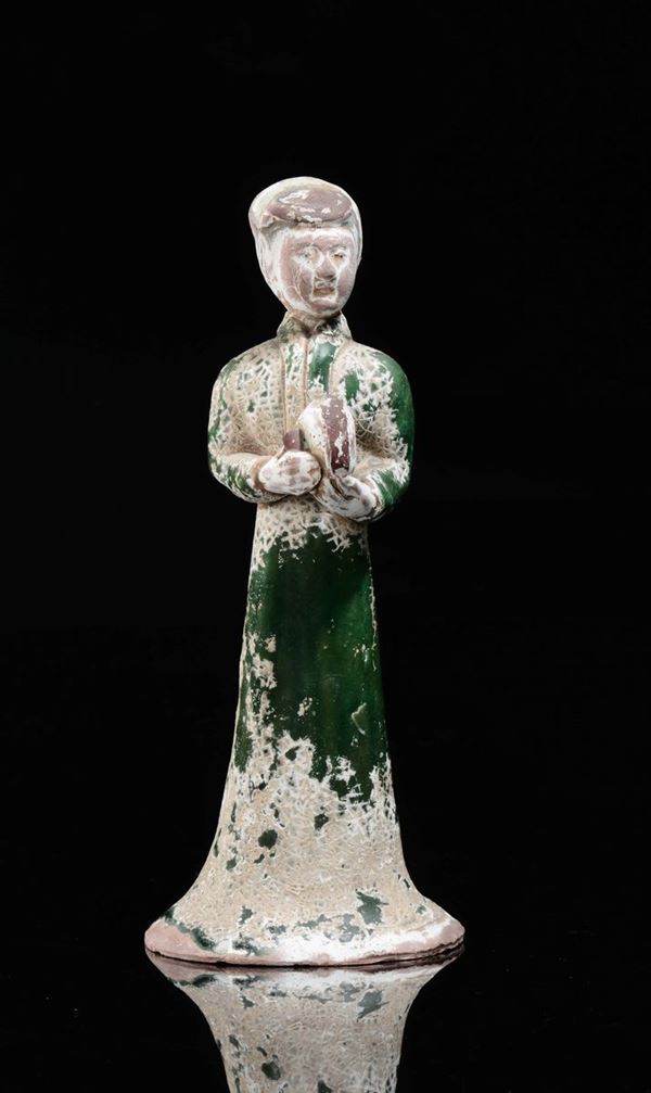 A semi-glazed green pottery figure of dignitary with tambourine, China, Tang Dynasty (618-906)