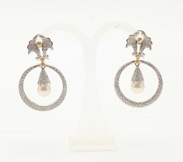 A pair of diamond, pearl and gold pendant earrings