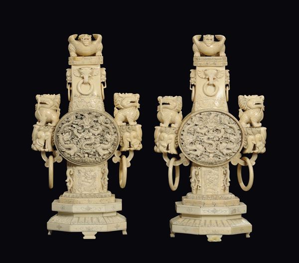 A pair of carved ivory vases and cover with double rings-handles with Pho dogs on top, China, Qing Dynasty, 19th century