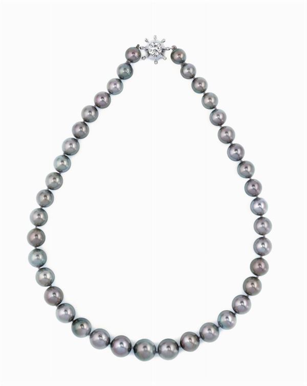 A grey cultured pearl necklace with a diamond clasp