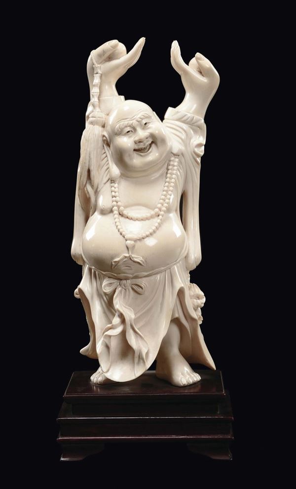 A carved ivory cheering Budai with raised arms, China, early 20th century