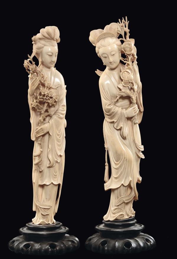 A pair of ivory Guanyin and flowers figures, China, Qing Dynasty, late 19th century