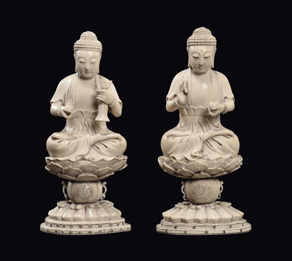 A pair of carved ivory Buddha on lotus flower sustained by chachepots, China, Qing Dynasty, 19th century