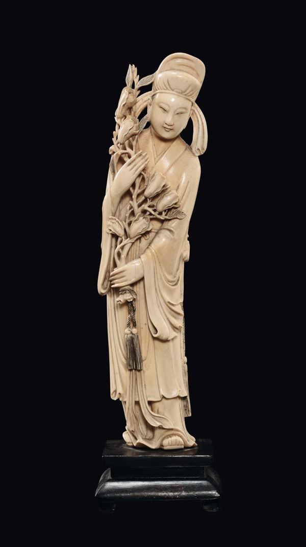 An ivory dignitary with flowers figure, China, Qing Dynasty, late 19th century