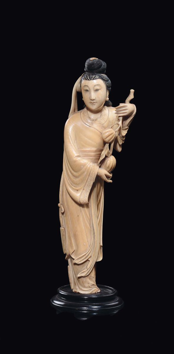 A Guanyin and fruits carved ivory, China, early 20th century