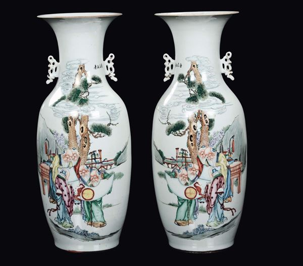 A pair of polychrome porcelain double handles vases with wise men and inscriptions, China, Republic, 20th century