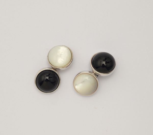 A pair of onix and moon stone cufflinks