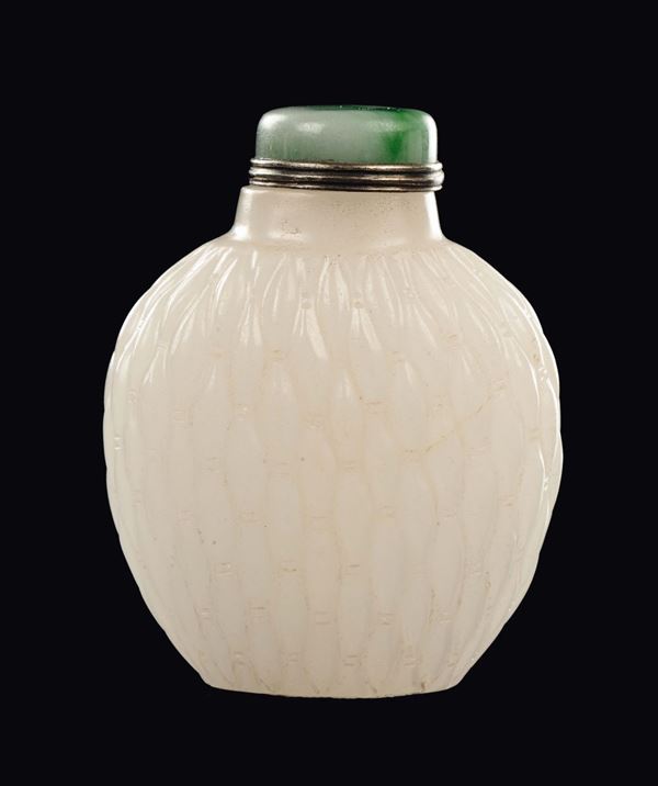 An embossed white jade snuff bottle with jadeite stopper, China, Qing Dynasty, 19th century