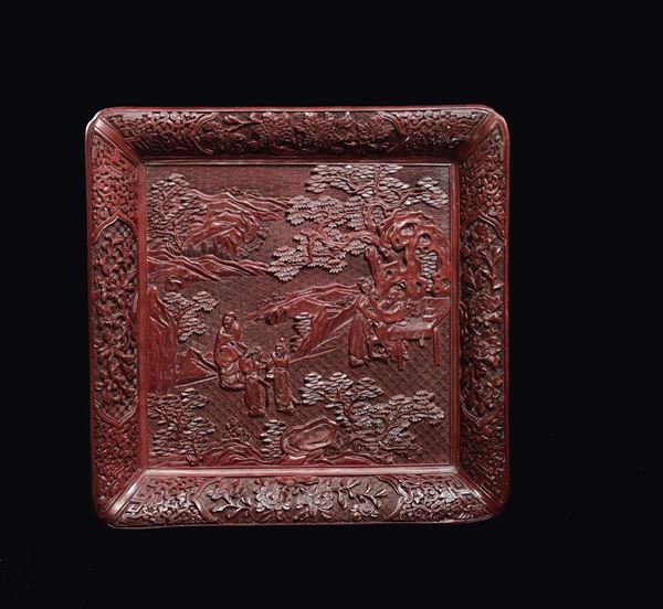 A carved red lacquer dish with Guanyin and dignitaries in a garden, China, Qing Dynasty, 19th century