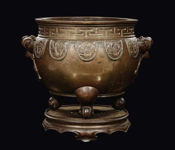 A large tripod censer and stand with raptor head handles, China, Qing Dynasty, Qianlong Period (1736-1795)