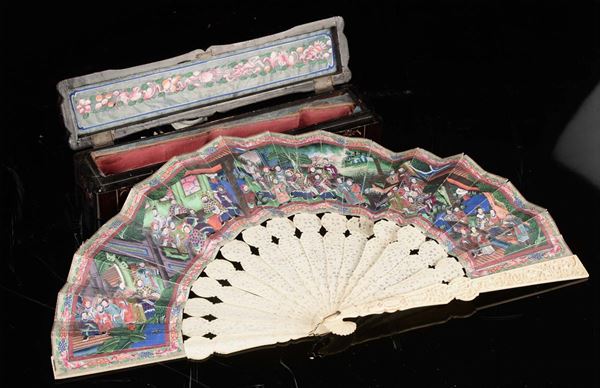 An ivory fan with wooden case depicting court life scenes, China, Qing Dynasty, 19th century