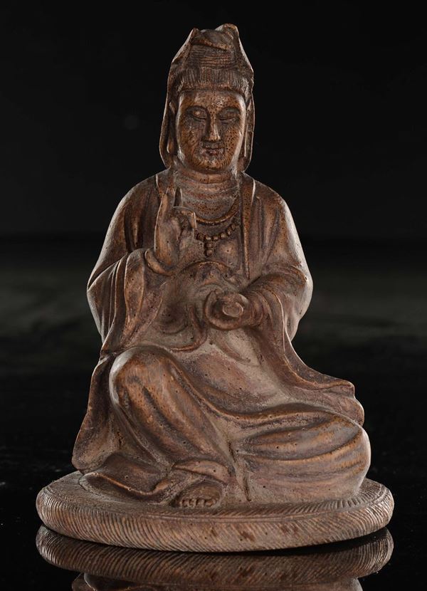 A carved wood Guanyin with parchment in her hand, China, Qing Dynasty, 19th century