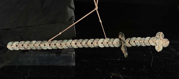 A ritual object consisting in coins intertwined shaped as a sword, China, Qing Dynasty, the 19th century