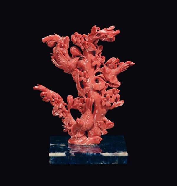 A carved coral branch with birds and flowers on lapislazuli base, China, Qing Dynasty, late 19th century