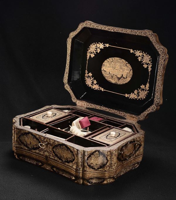 A lacquered wooden box with figures within reserves containing spools ivory, China, Qing Dynasty, 19th century