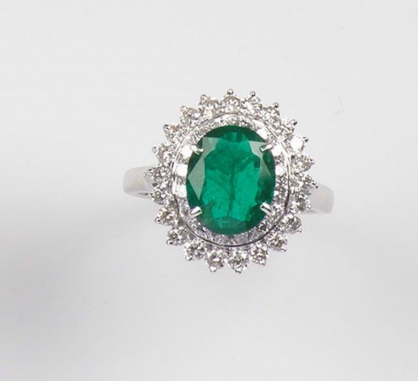 An emerald and diamond cluster ring. Mounted in white gold 750/1000