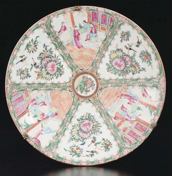 A polychrome enamelled porcelain dish with roses and court life scenes within reserves, China, Qing Dynasty, 19th century