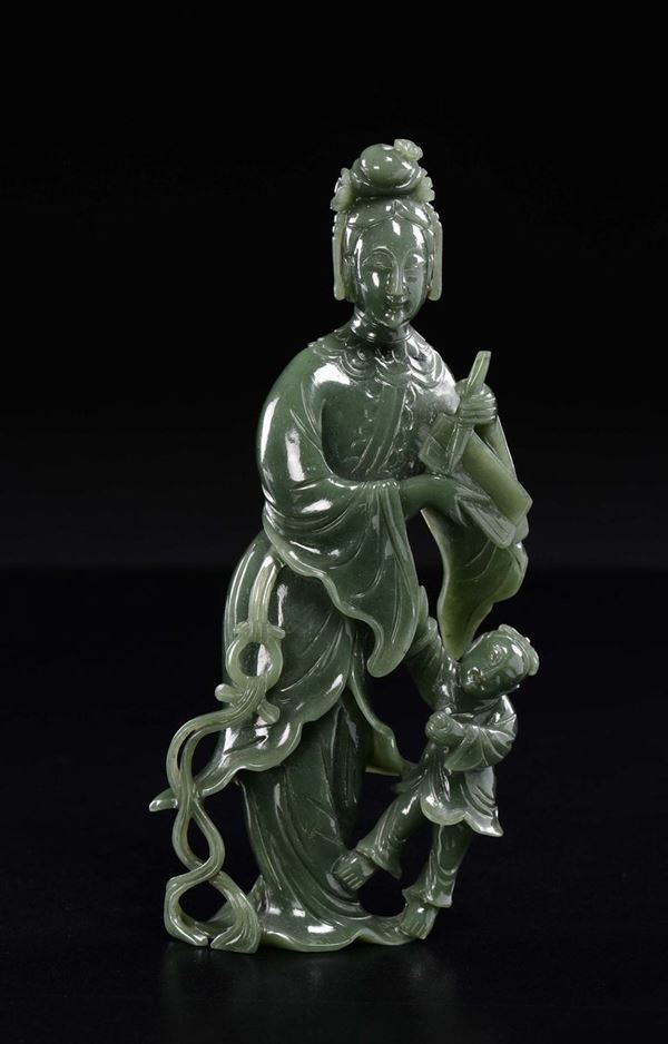 A spinach green jade figure of Guanyin with child, China, 20th century