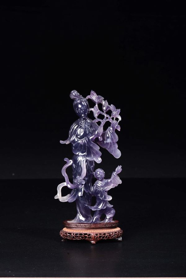 A carved amethyst figure of Guanyin and child, China, 20th century