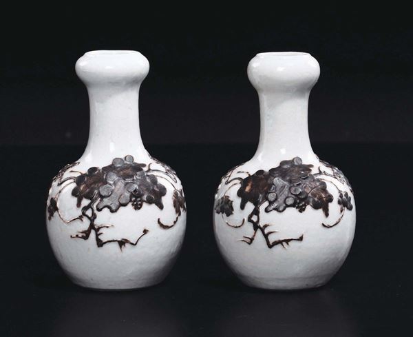 A pair of craquelè porcelain vases with grapes in relief, China, Qing Dynasty, 19th century