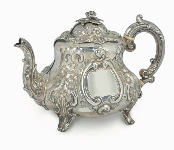 An embossed, molten and chiselled silver tea-pot, silversmith Richard Hennez, London 1863