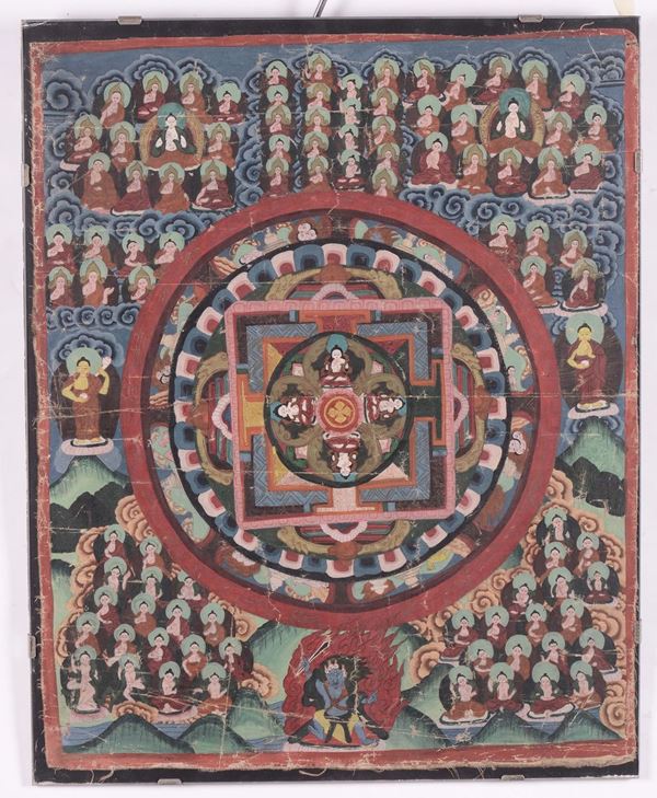 A framed blue and green-ground tanka with numerous deities, Tibet, 20th century