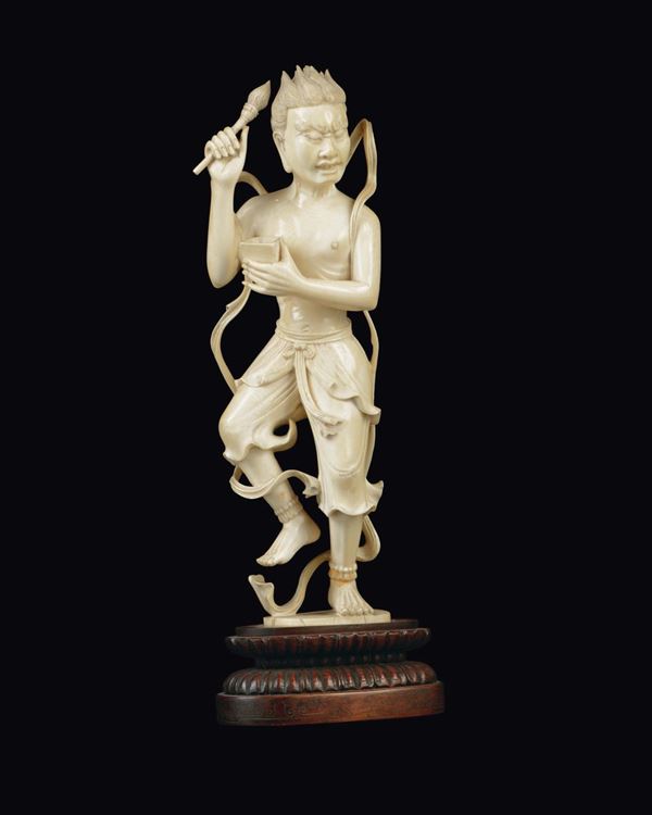 A carved ivory figure of scribe holding a brush, China, Republic, early 20th century