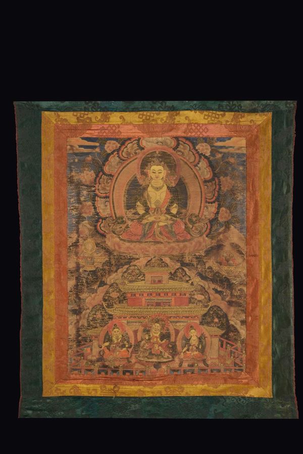 Tanka dipinto incorniciato con divinità  centrale su fiore di loto, Tibet, XIX secolo