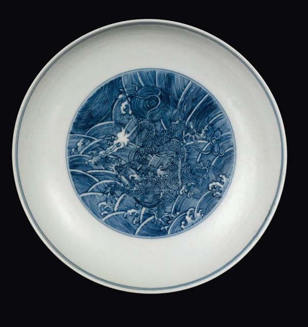 A blue and white dish with dragon within reserve, China, Qing Dynasty, Qianlong Mark and Period (1736-1795)