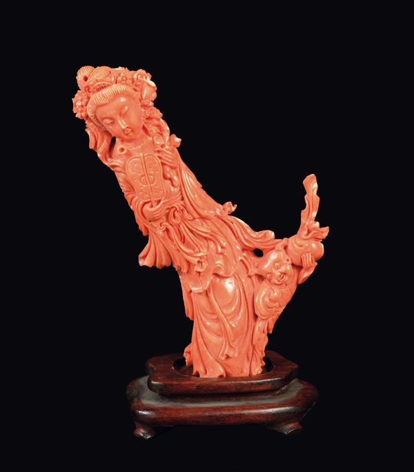 A carved coral Guanyin figure with fan, China, early 20th century