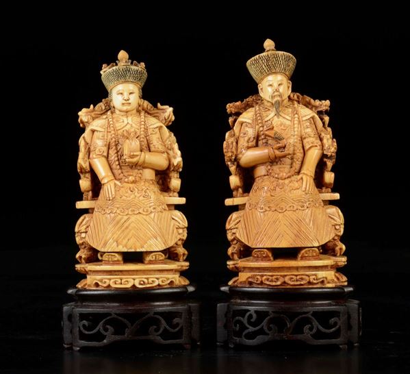 A pair of carved ivory sitting emperors, China, early 20th century