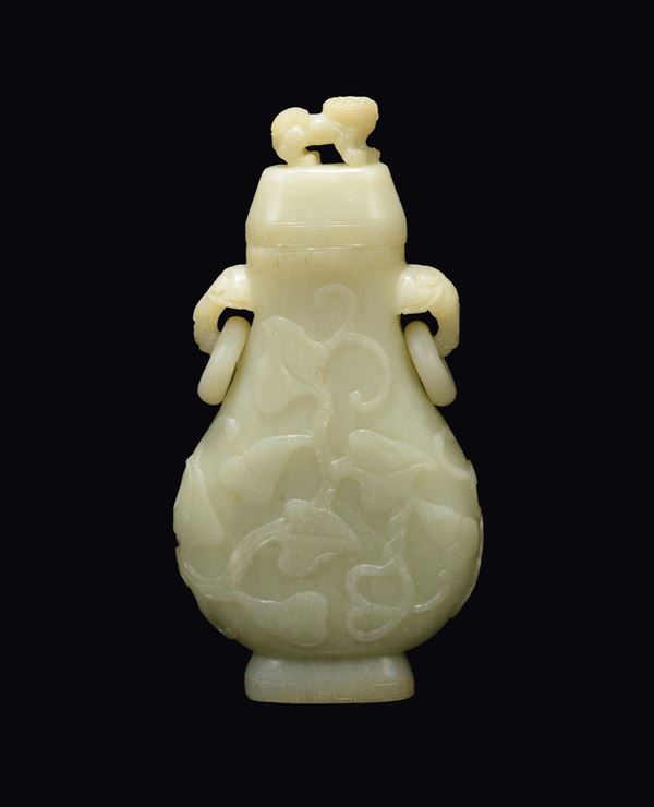A white jade vase and cover with a naturalistic decor in relief with elephant-head double handle with rings, China, Qing Dynasty, 19th century