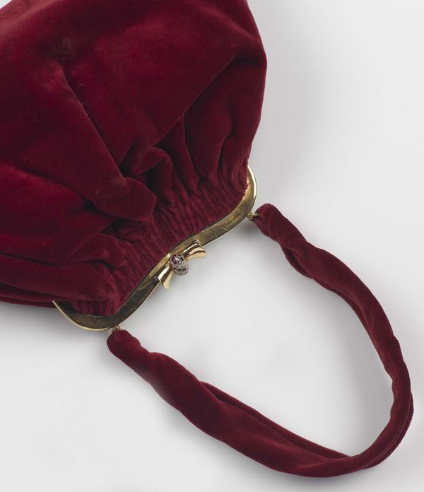 A gold, diamond, ruby and red velvet purse