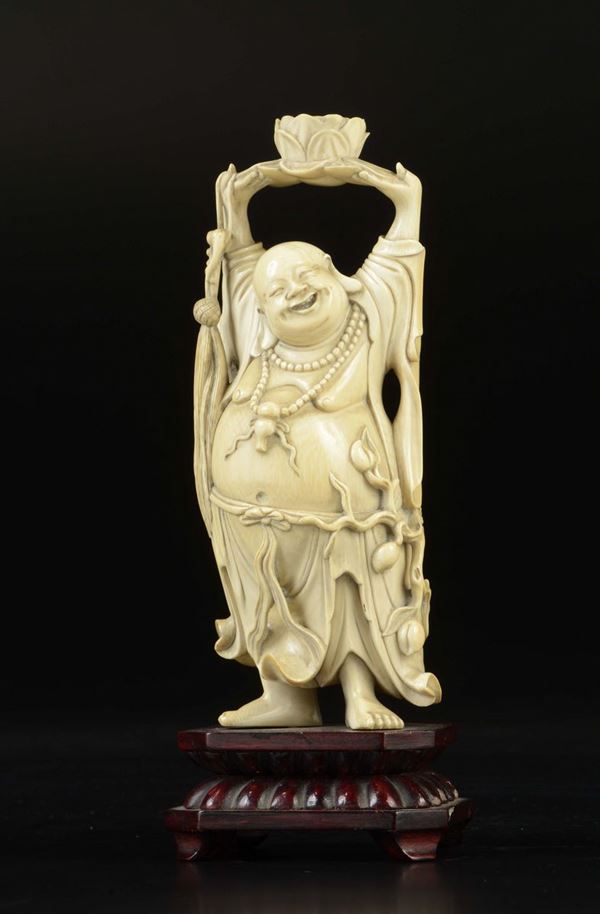 A carved ivory figure of Budai with lotus flower, China, early 20th century