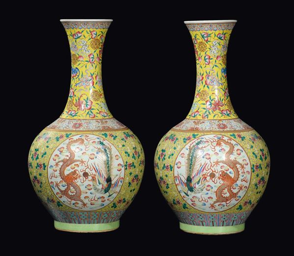 A large and important fine pair of porcelain bottle vases yellow-ground with phoenixes and dragons within  [..]