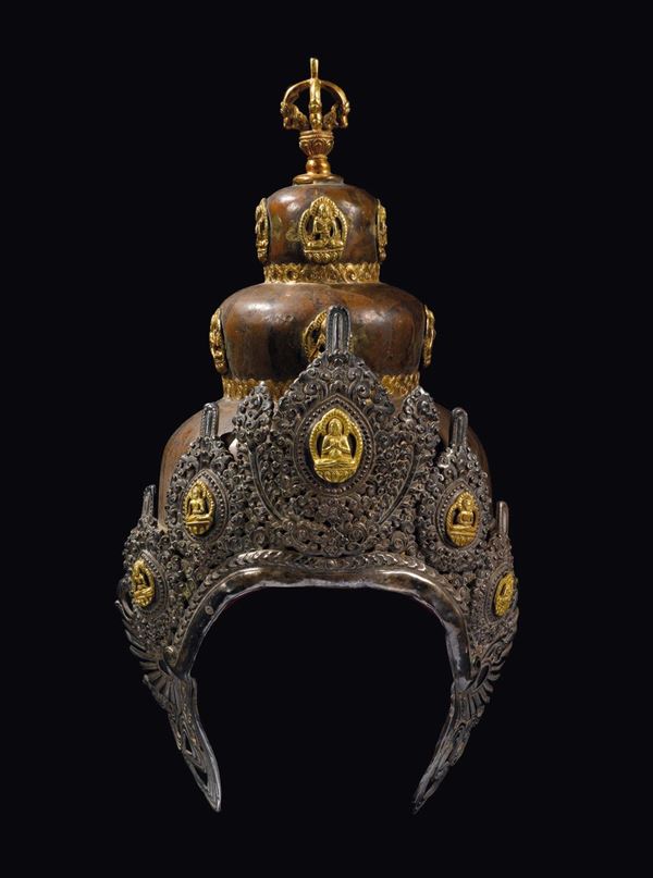 A gilt repoussè copper helmet with deities, Tibet, 19th century