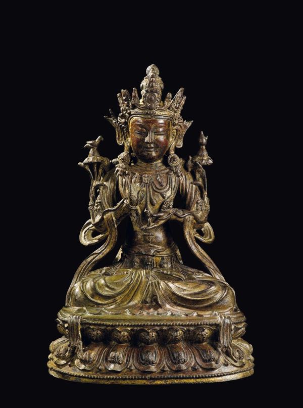 A large semi-gilt bronze figure of crowned Buddha on a double lotus flower, China, Ming Dynasty, 17th  [..]