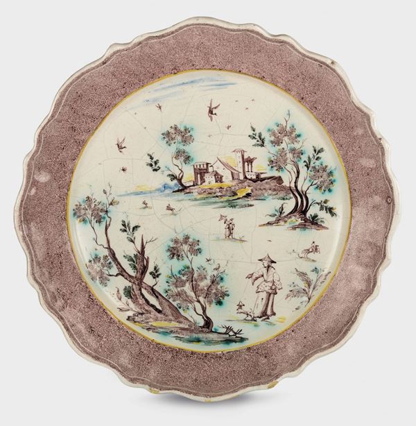A pair of large majolica plates, one of which marked on the back with a small eagle and F, Savona, Folco or Ferro manufacture, mid-18th century
