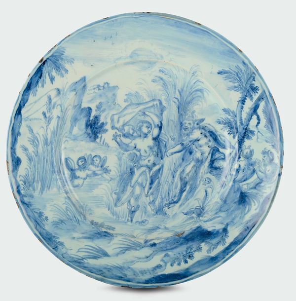 A white and blue majolica plate with “baroque scenography” decoration, stylized emblem mark, Savona, around 1680