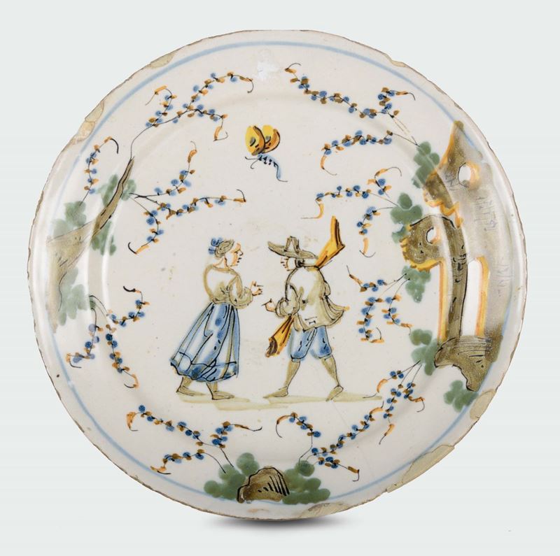 A polychrome majolica plate with two figures and ruins, fortress mark, Ferro Guidobono manufacture, Savona, early 18th century  - Auction Mario Panzano, Antique Dealer in Genoa - Cambi Casa d'Aste