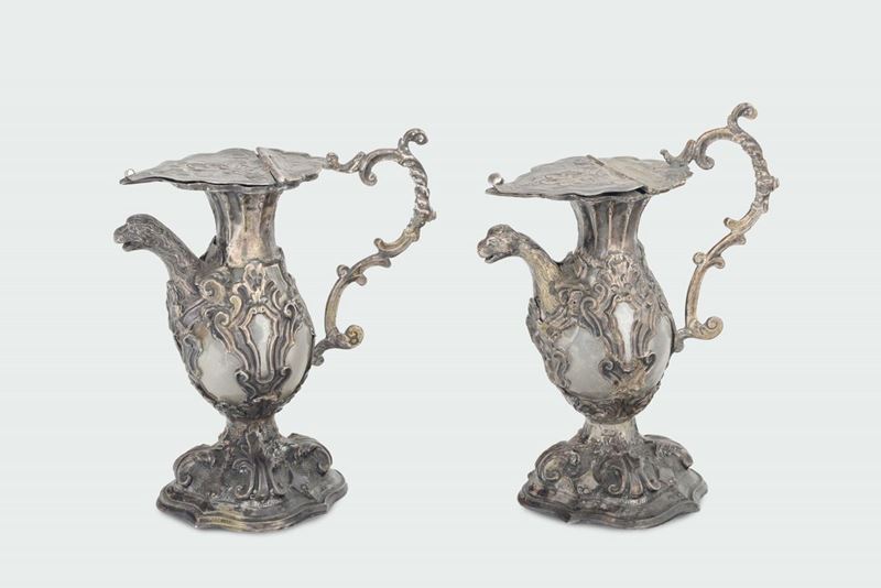A pair of molten, embossed, chiselled and carved silver and blown glass ampoules, Lombard-venetian mark used from 1812 to 1872 and by the silversmith  - Auction Fine Silvers - I - Cambi Casa d'Aste