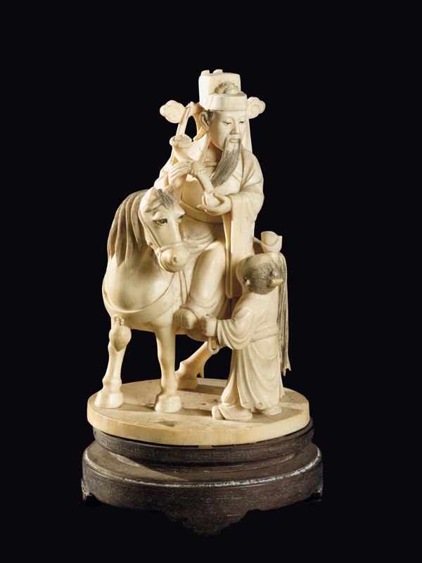A carved ivory dignitary with ruyi on a horse and child group, China, Qing Dynasty, late 19th century