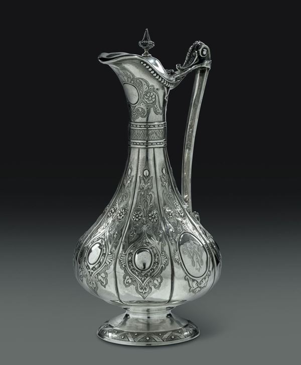 A pitcher in embossed and chiselled silver, London 1881 ca.