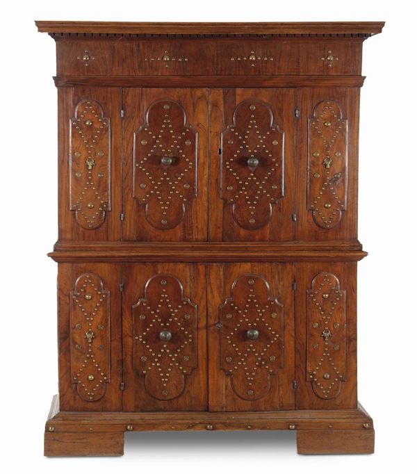 A double-body walnut veneered cupboard decorated with bronze studs, Boulogne, late 16th century