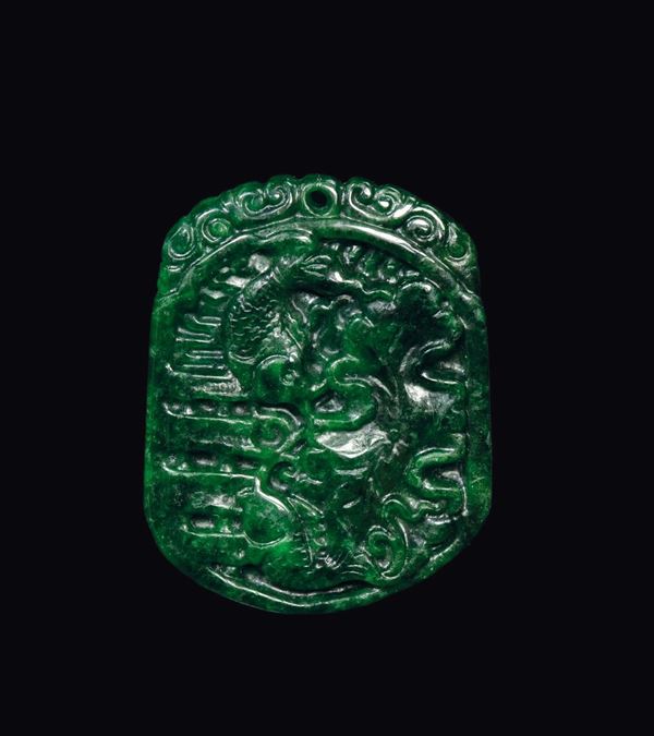 A spinach green pendant with fish in relief, China, early 20th century