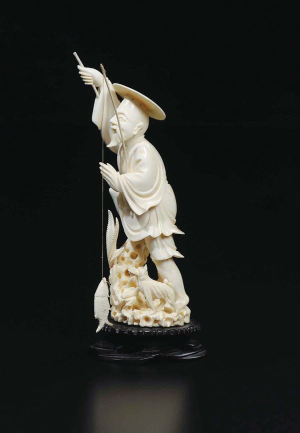 A carved ivory fisherman with fishing rod and dog, China, early 20th century