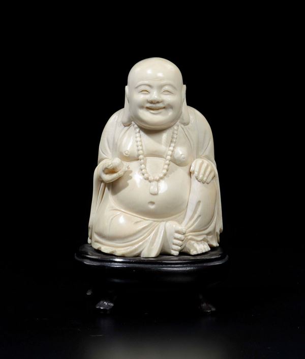 A carved ivory figure of Budai with fruit, China, early 20th century