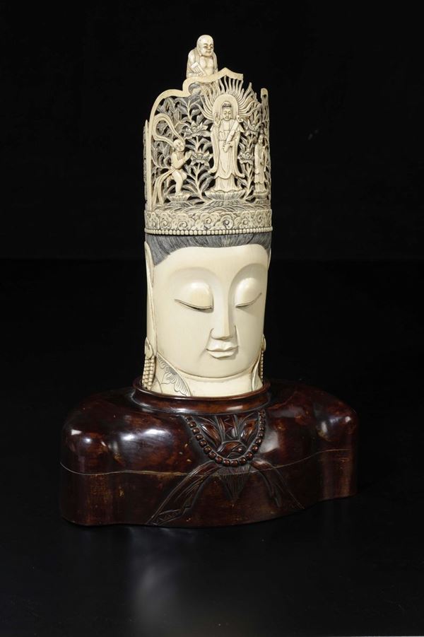 A carved ivory Buddha's head with wise man figures on his crown, China, early 20th century