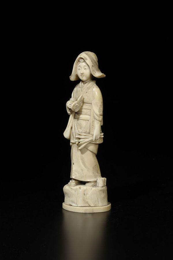 A carved ivory peasant with wire cutters and bundle, Japan, early 20th century